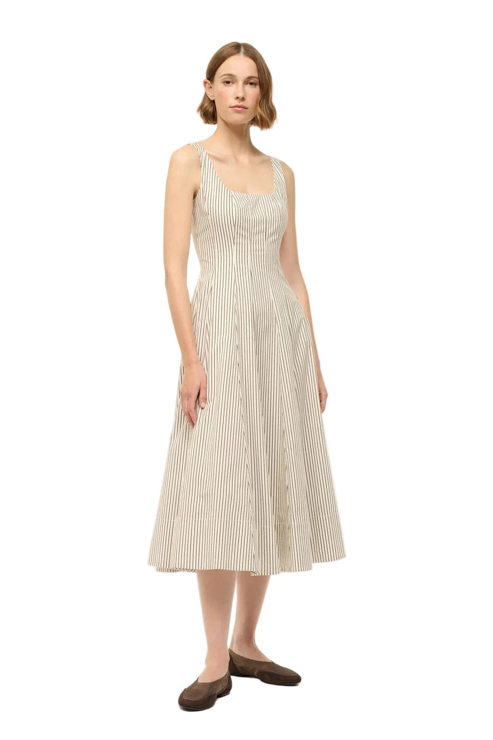 Model wearing the Wells Dress in Ivory/Dark Oak Micro Stripe by Staud with a flattering fitted silhouette.