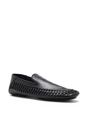 Close-up of Proenza Schouler Whip Loafers in Black featuring the rounded tongue and monogram-embossed rubber sole.