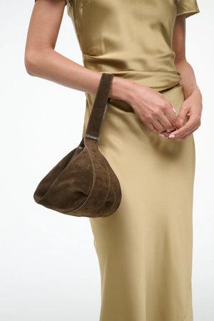 Demy Shoulder Bag in Truffle being worn over the shoulder, demonstrating its fashionable versatility.