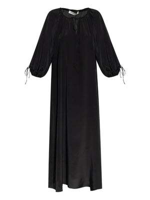 Lily Dress in Black by By Malene Birger showcasing its voluminous shape and adjustable straps against a simple background.