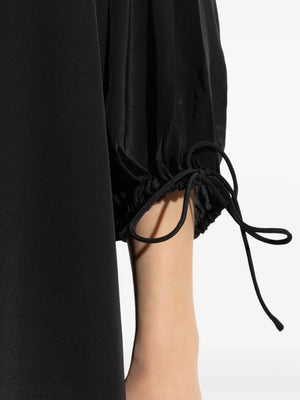 Detail shot of the adjustable straps on the Lily Dress in Black by By Malene Birger, emphasizing the custom fit and comfort.