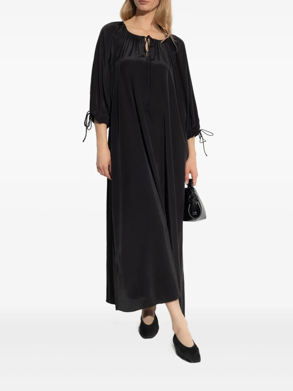 Close-up of the fabric texture of the Lily Dress in Black by By Malene Birger, highlighting its silk-blend composition.