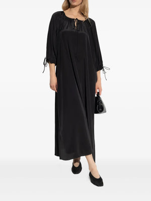 Close-up of the fabric texture of the Lily Dress in Black by By Malene Birger, highlighting its silk-blend composition.