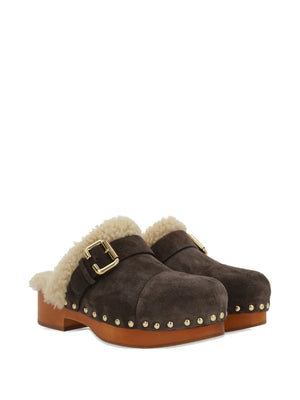 Close-up view of Chloé's Jeanette Clog in Burnt Wood showcasing gold-tone studs and iconic Paddington buckle.