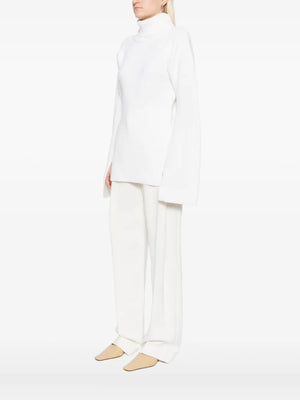 Elegant Slit Sleeve Knit in Ecru by TOTEME, showcasing a fashionable turtleneck sweater women perfect for chilly summer nights.