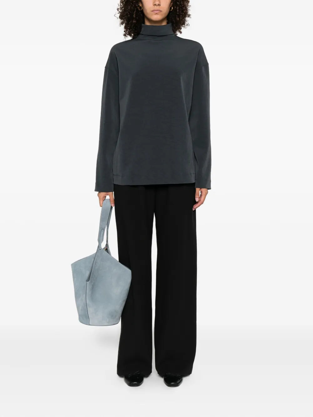Close-up view of Nanushka's Arvenn Pants in Black, highlighting the soft twill suiting material and sophisticated design.