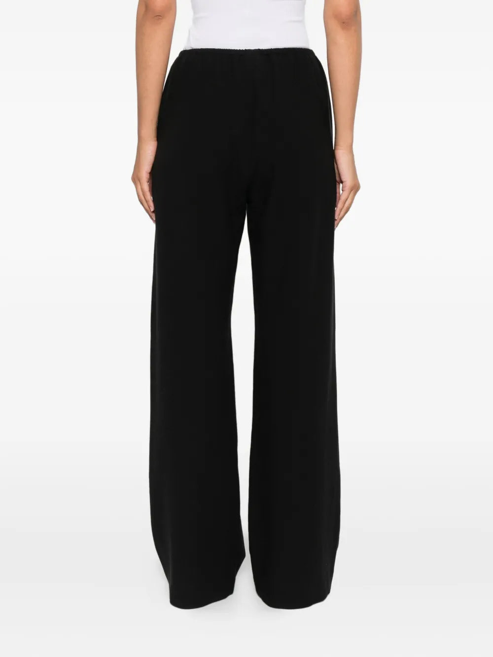 A stylish view of the Nanushka Arvenn Pants in Black, focusing on the luxurious fabric and tailored look perfect for various occasions.