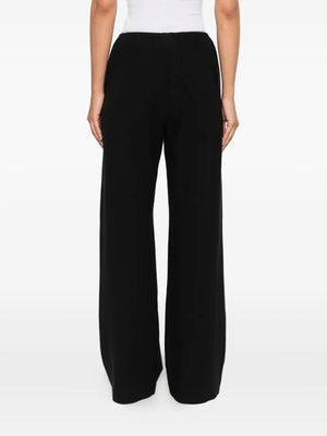 A stylish view of the Nanushka Arvenn Pants in Black, focusing on the luxurious fabric and tailored look perfect for various occasions.