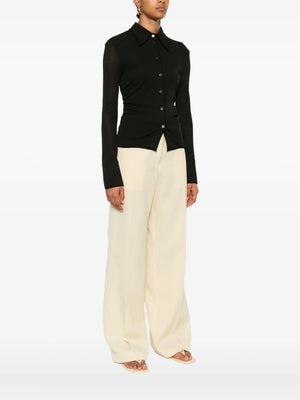 Nanushka Idana Shirt in Black - side view illustrating the flattering silhouette and unique mesh texture.