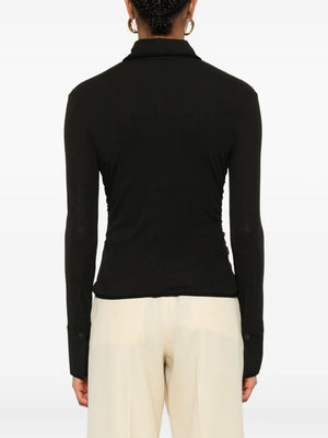 Back view of the Nanushka Idana Shirt in Black, featuring the elegant design with contrasting binding details.
