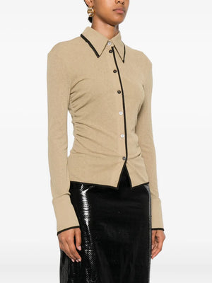 Model wearing Nanushka Idana Shirt in Sand, styled for a chic casual look.