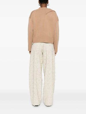 Elson Wool Cashmere Scarf Sweater in Camel - model wearing the sweater to illustrate its fashionable fit.