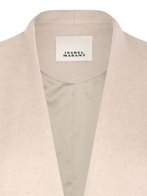 Dramatic angle of the Florane Coat in Ecru highlighting its modern silhouette and texture.