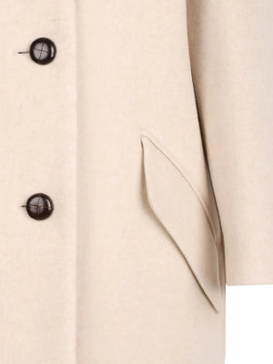 Model wearing the Florane Coat in Ecru, elegantly styled for a chic autumn look.