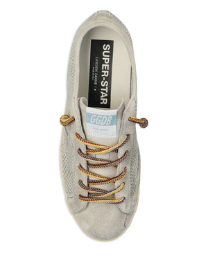 Detailed shot of the grey suede upper and heel tab of the Golden Goose Super Star sneakers.