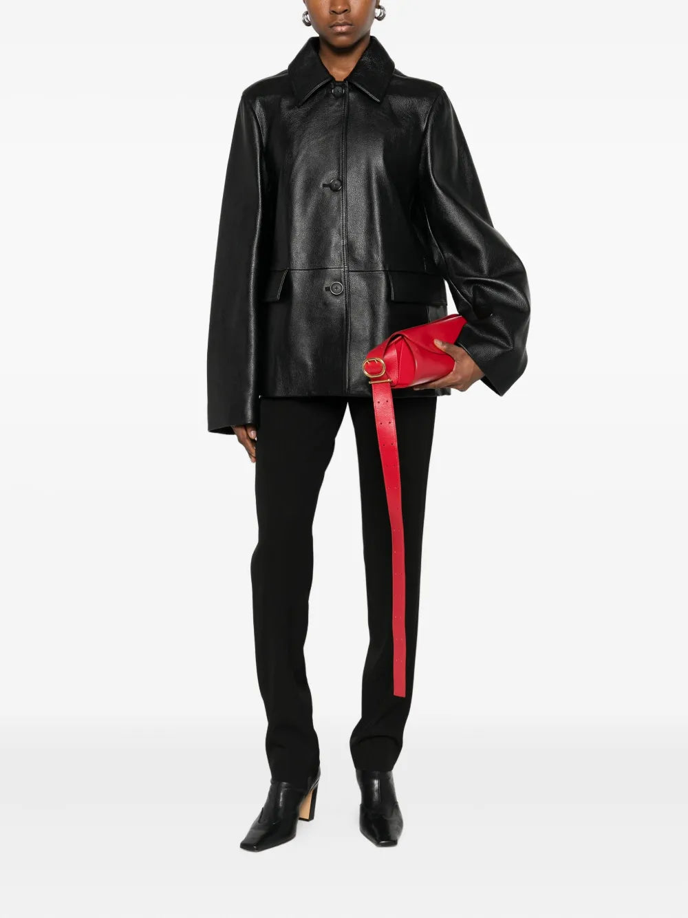 Back view of the Grained Leather Jacket in Black by TOTEME, highlighting its clean lines and soft satin interior.