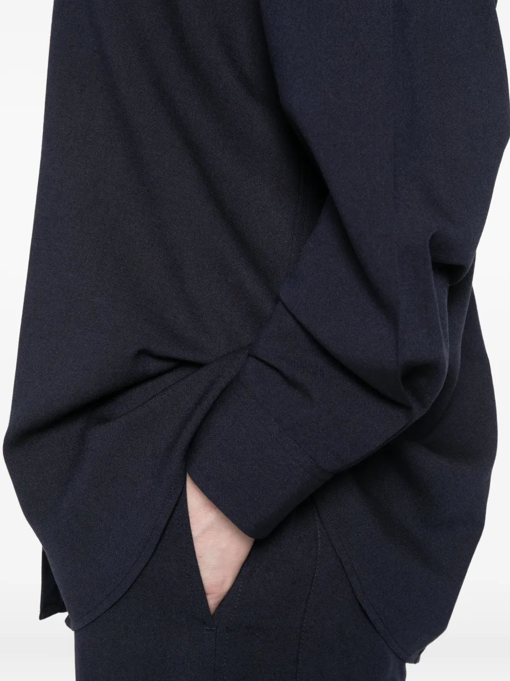 Fluid Classic Shirt in Navy by TOTEME presented on a hanger, emphasizing its fluid viscose-wool blend.