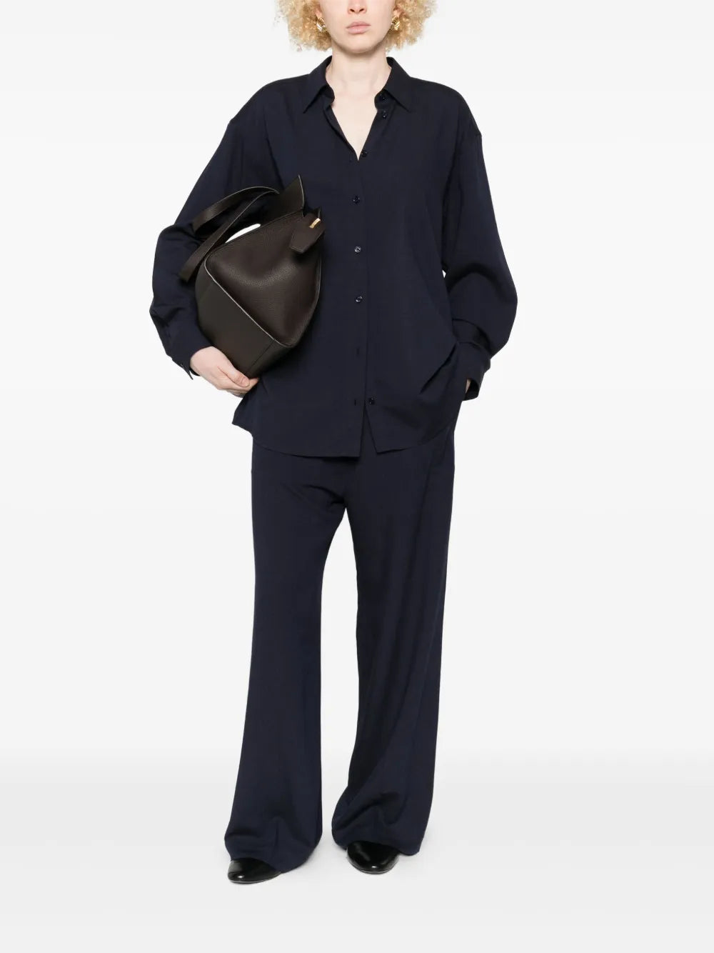 Close-up of the buttoned placket and cuffs on the Fluid Classic Shirt in Navy by TOTEME.