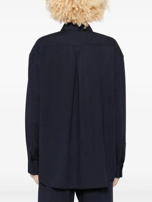 Back view of the Fluid Classic Shirt in Navy by TOTEME highlighting the longline design.