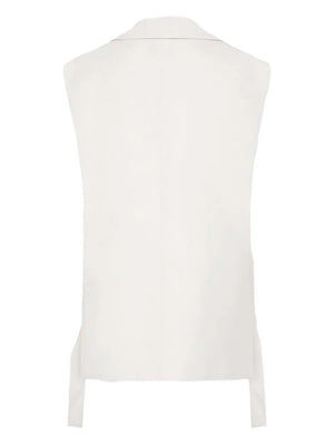 Stylish display of the Relaxed Side Tie Vest in Off White paired with tailored bottoms, demonstrating versatile fashion choices.