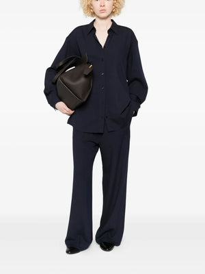 Stylish Fluid Winter Trousers in Navy from TOTEME, featuring flared wide legs and high waist for a relaxed winter look.