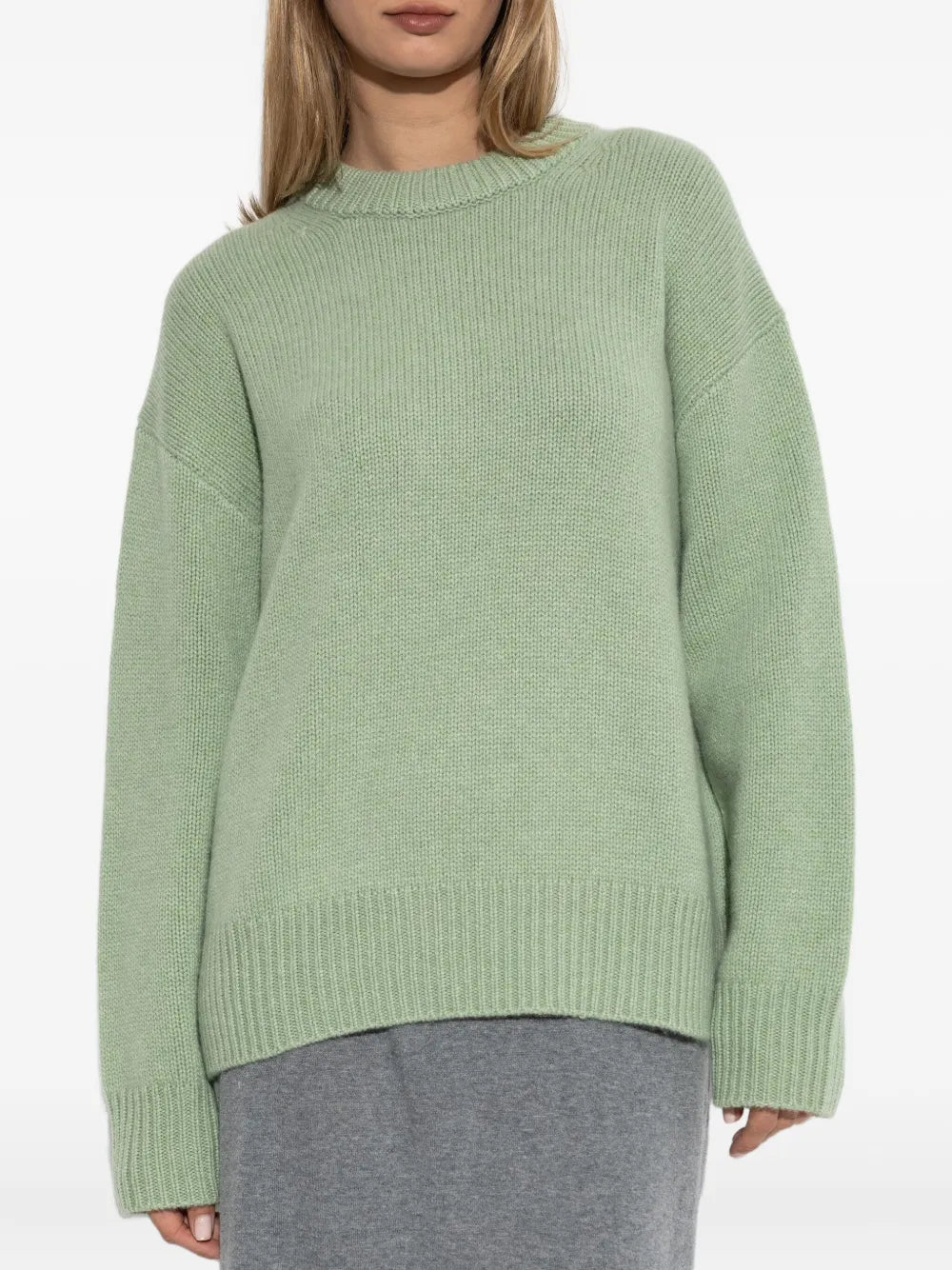 Renske Sweater in Seafoam worn casually emphasizing the extended ribbed hem and elongated sleeves.