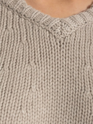 Oia Sweater in Sand on display, emphasizing its elegance and comfort for colder months.