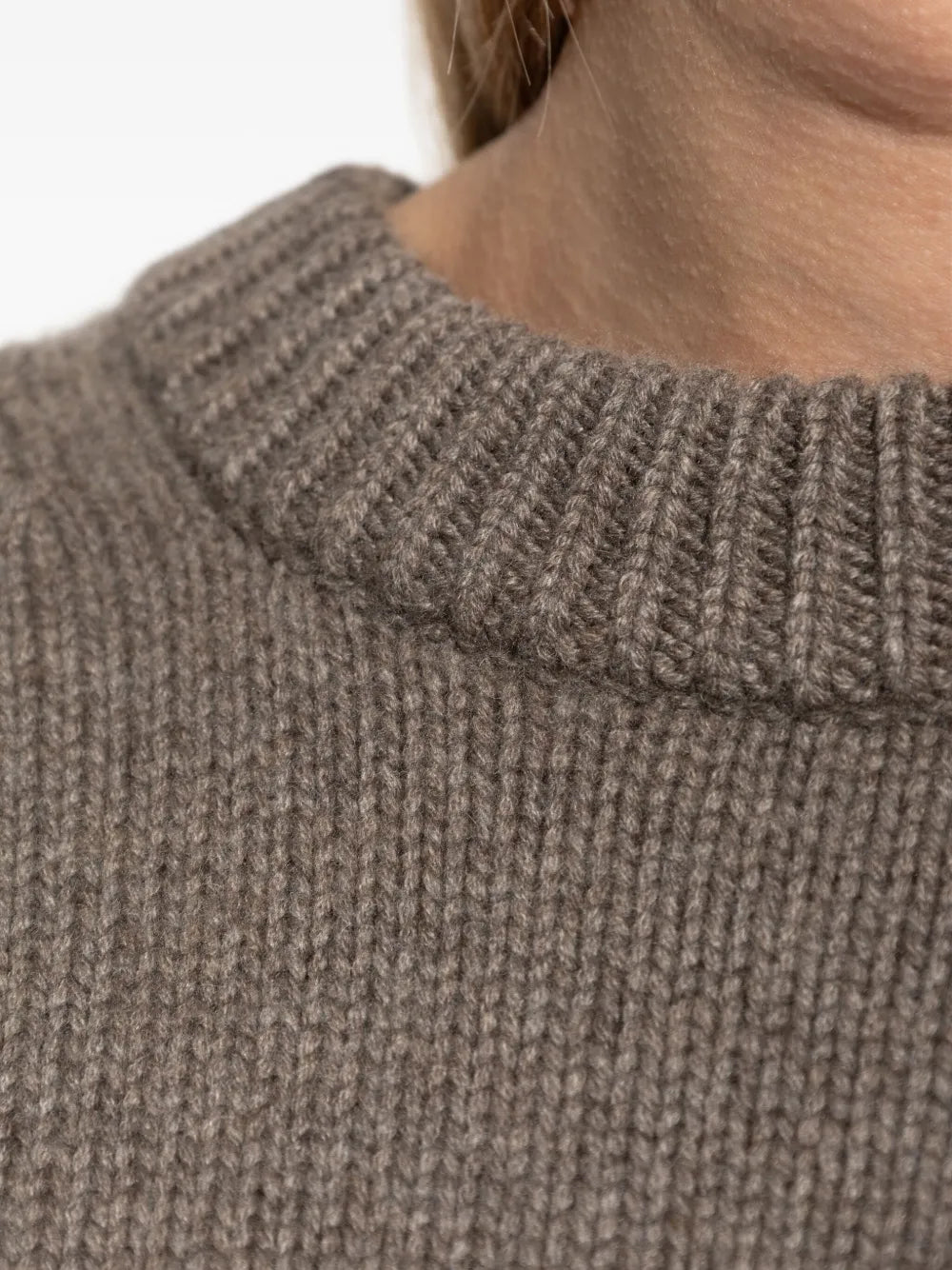 The Renske Sweater in Truffle worn casually, showcasing its versatile design perfect for layering.