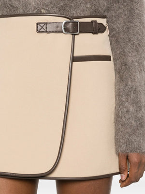 Flat lay of Simkhai's Sheridan Mini Skirt in Light Camel against a stylish backdrop.