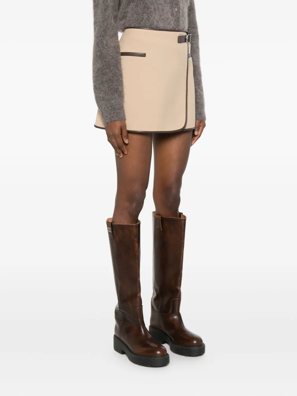 Model wearing the Sheridan Mini Skirt in Light Camel, perfect for a chic casual look.