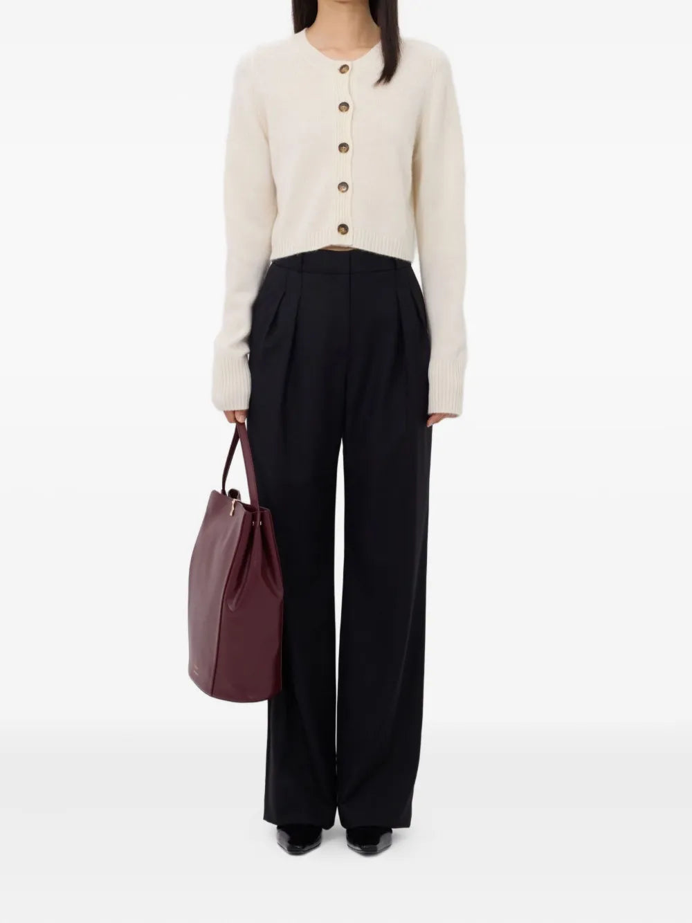 Close-up view of the Zephir Cropped Cashmere Cardigan in Ivory highlighting the ribbed crew neck and five button front detail. A must-have cropped cashmere cardigan.