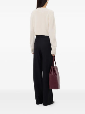 Back view of the Zephir Cropped Cashmere Cardigan in Ivory emphasizing the comfortable fit and quality craftsmanship. Discover the elegance of this cropped cashmere cardigan.