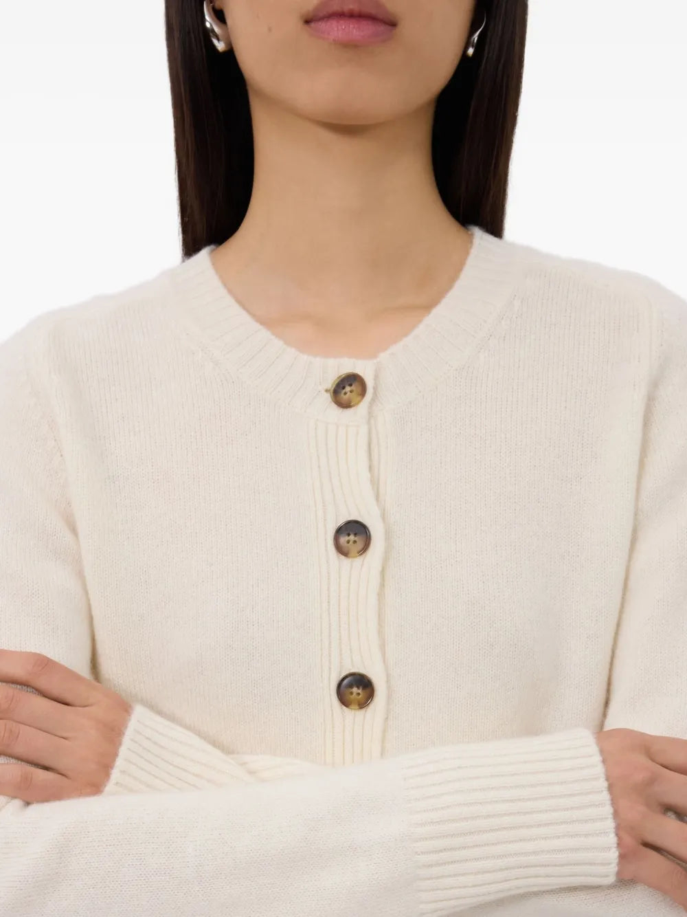 Flat lay of the Zephir Cropped Cashmere Cardigan in Ivory, illustrating its soft texture and premium cashmere fabric. A luxurious cropped cashmere cardigan to elevate your wardrobe.