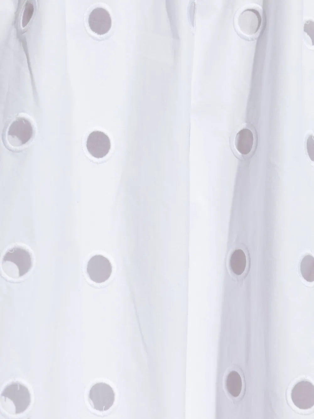 Flat lay of the Peggy Skirt in Vintage White showing the exquisite laser cut embroidery on this cotton laser cut skirt.