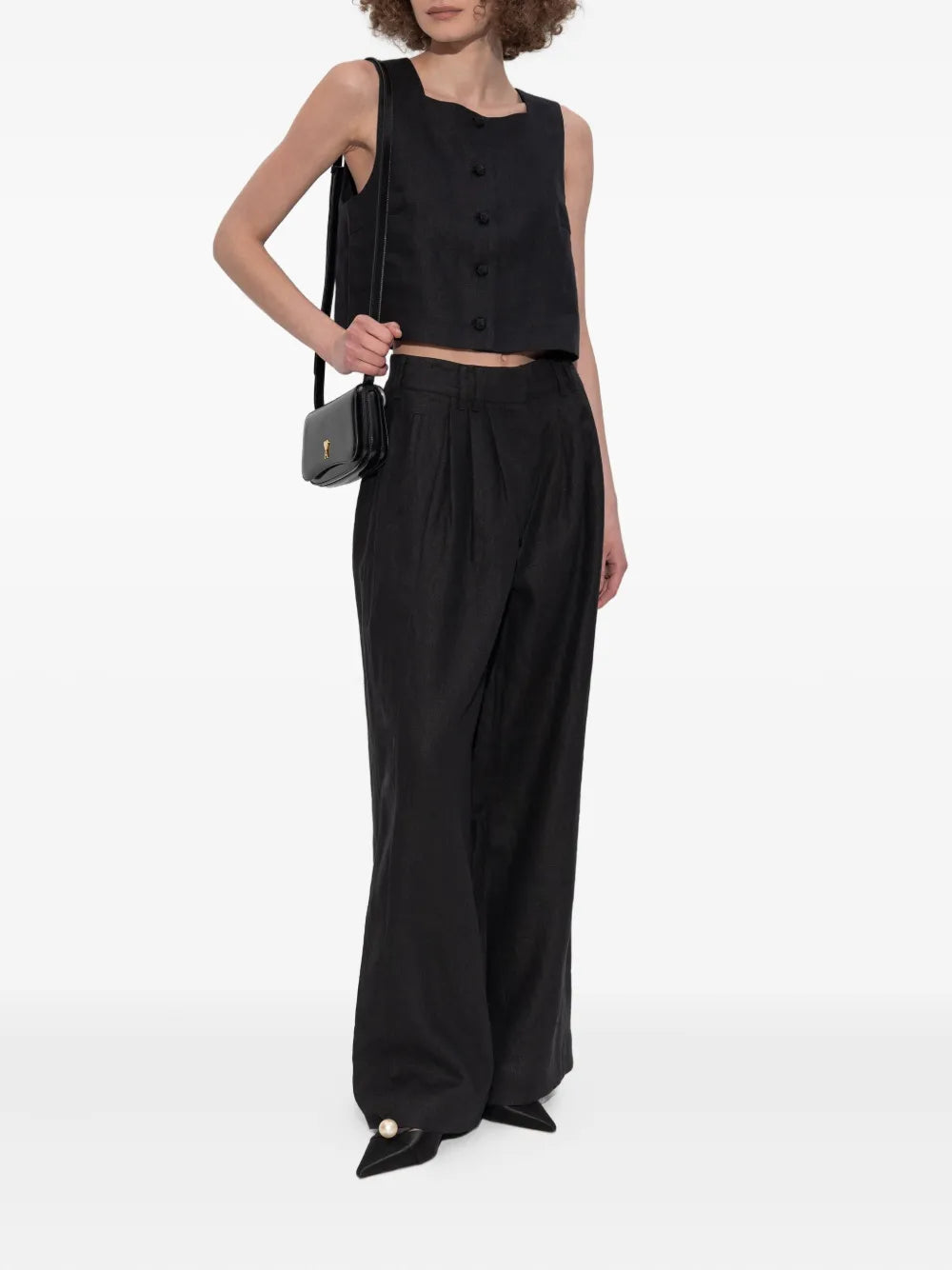 Close-up of the antique-inspired covered buttons on the Rio Top in Black, a chic black crop top.