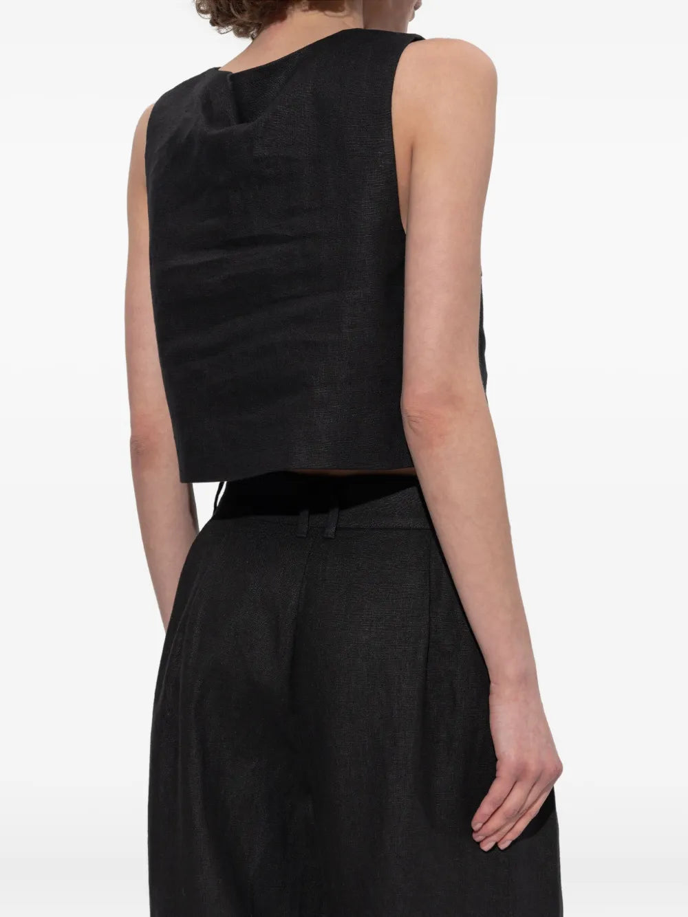 The Rio Top in Black displayed flat, highlighting the unique crop silhouette of this black crop top.