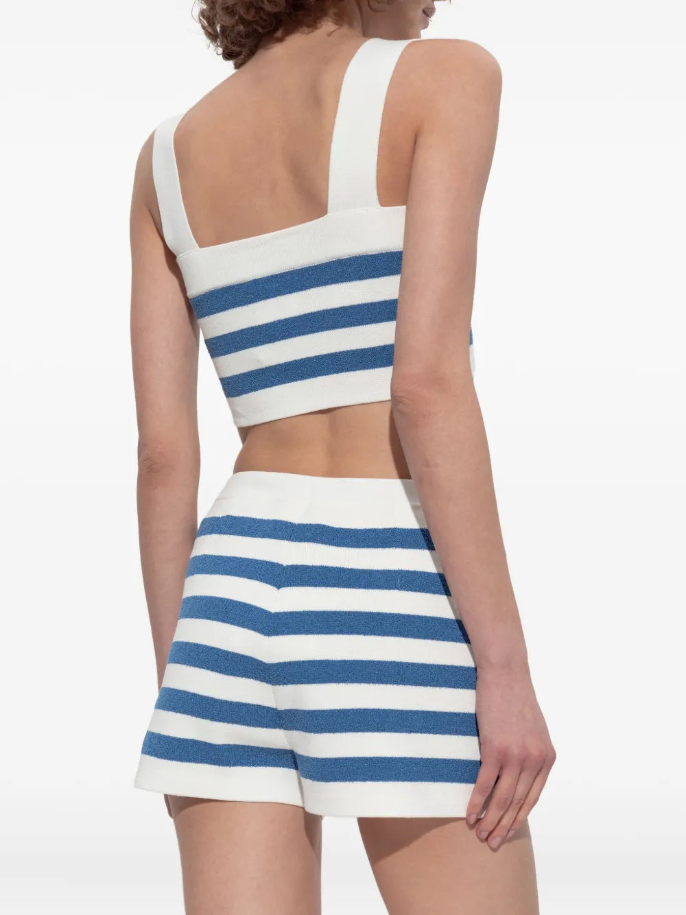 Ari Crop Top in Blue Stripe displayed elegantly on a hanger, highlighting its stylish design as a trendy blue stripe crop top for your wardrobe.