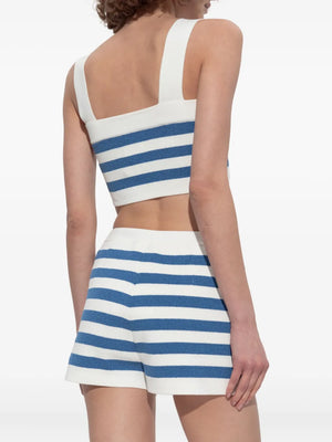Ari Crop Top in Blue Stripe displayed elegantly on a hanger, highlighting its stylish design as a trendy blue stripe crop top for your wardrobe.