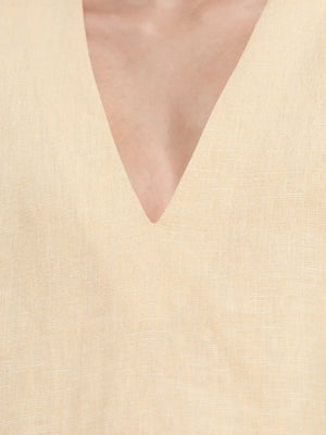 Flat lay of the Essie Kaftan in Dusty Citron, a chic mini kaftan dress made from 100% linen.