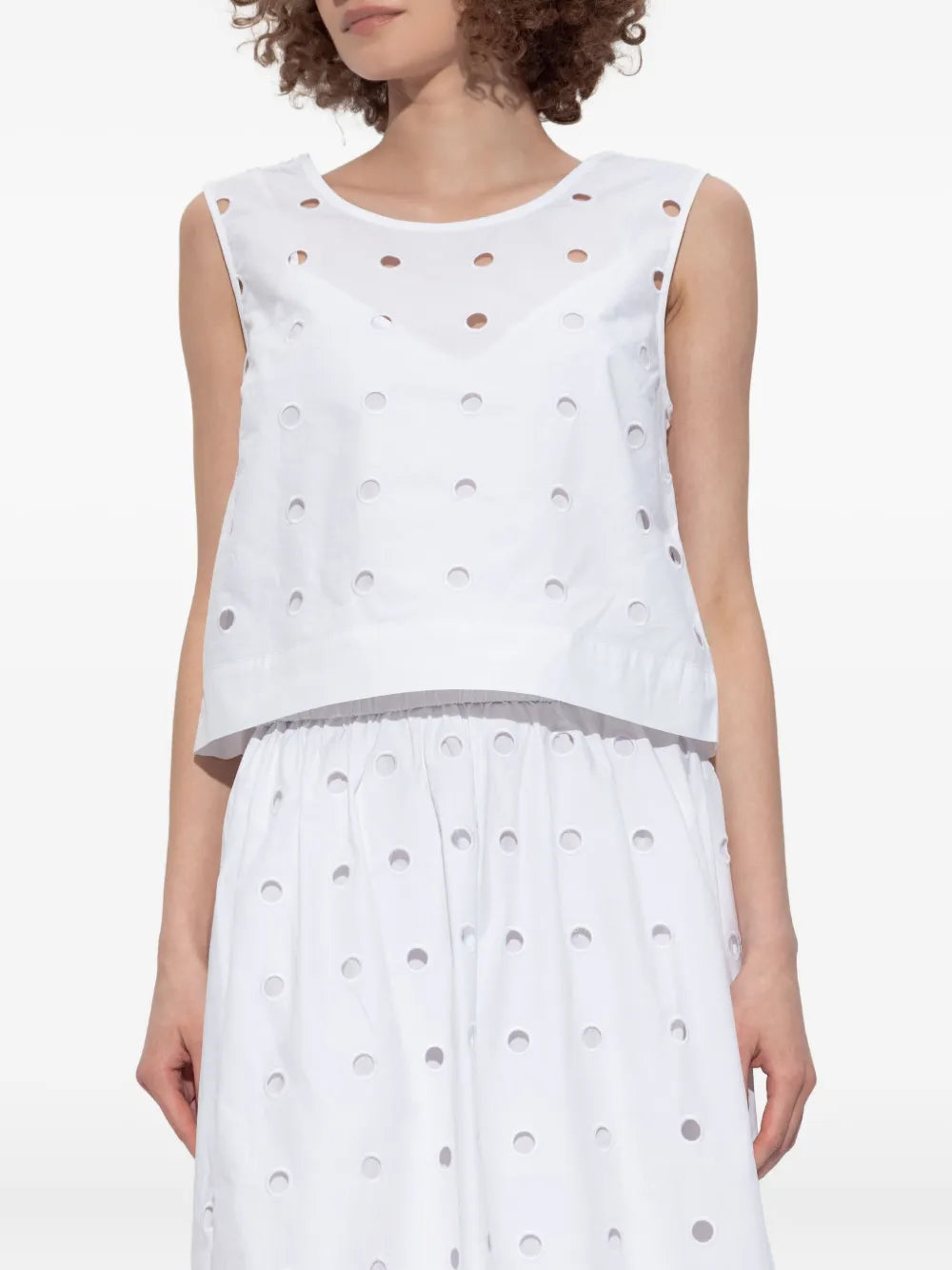Side view of the Peggy Top in Vintage White showcasing its boxy silhouette and elegant design.