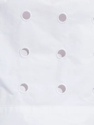 The Peggy Top in Vintage White laid flat, highlighting the high neckline and laser cut embroidery pattern.
