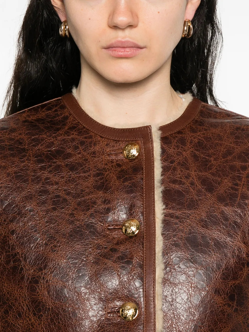 Flat lay of the Zanie Short Shearling Coat in Vintage Whiskey showcasing its luxurious lamb fur and handcrafted quality.