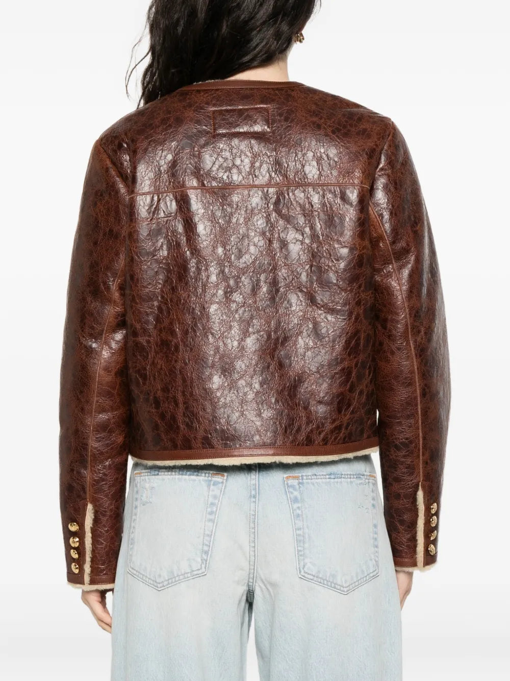Model wearing the Zanie Short Shearling Coat in Vintage Whiskey paired with stylish accessories and apparel.
