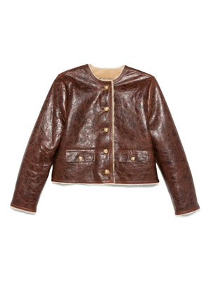 Zanie Short Shearling Coat in Vintage Whiskey displayed on a mannequin showcasing its cropped design and leather trim.