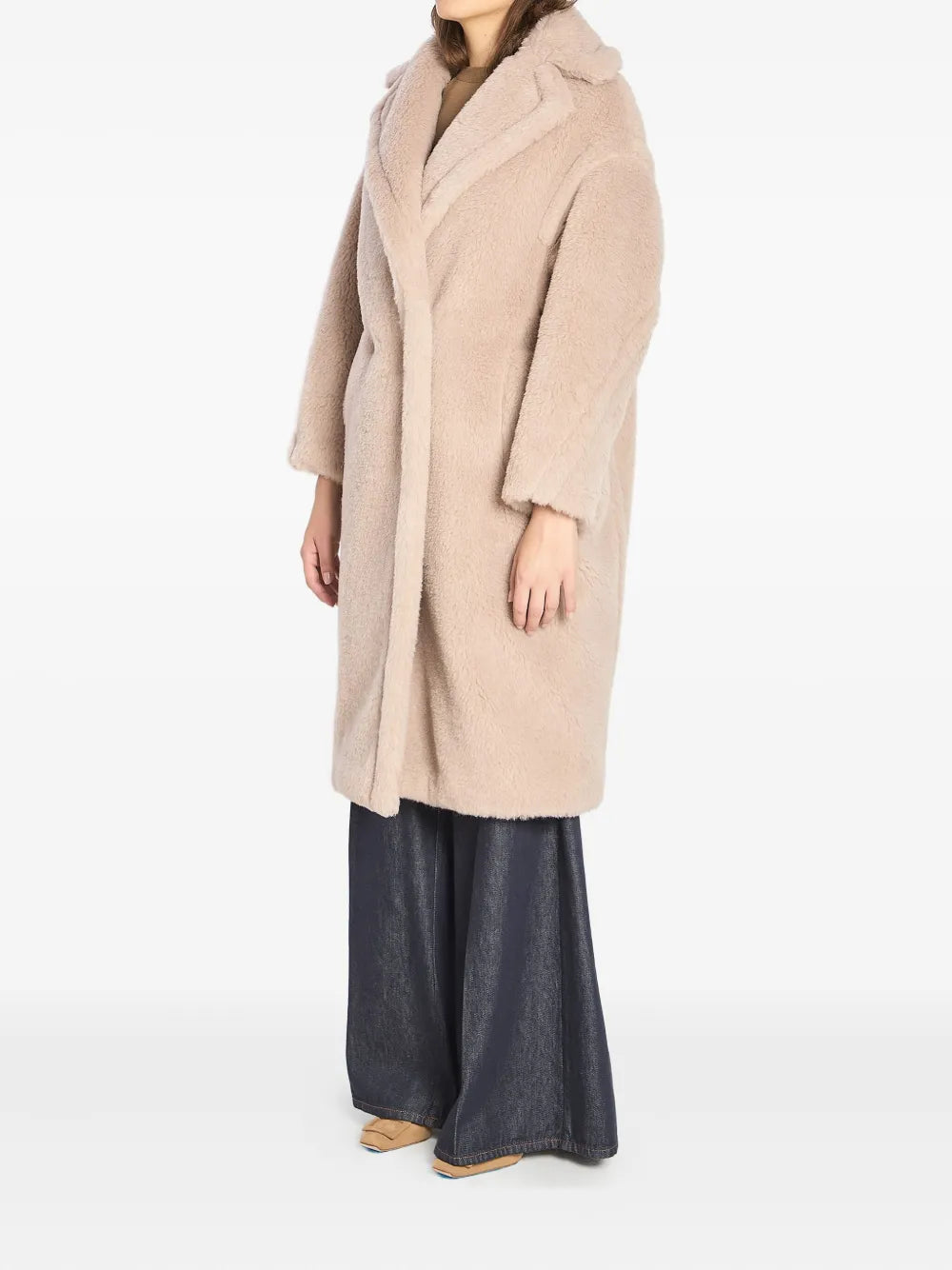 Model wearing the beige Max Mara Teddy Bear Icon Coat in a stylish outdoor setting.
