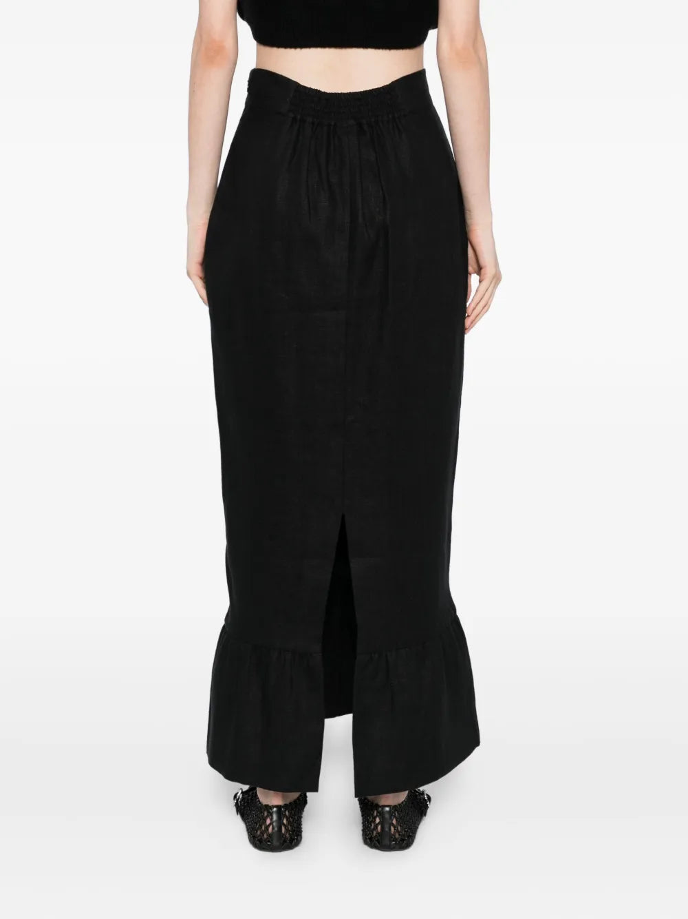 Back view of the Matilda Column Skirt in Black, emphasizing the flowing frilled hem and premium linen fabric.