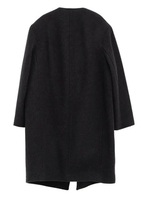 Fashionable Bell-Sleeve Jacket in Black by TOTEME styled over a dress, ideal for evening wear.