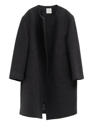 Bell-Sleeve Jacket in Black by TOTEME showcasing sculptural bell sleeves and a minimalist silhouette.