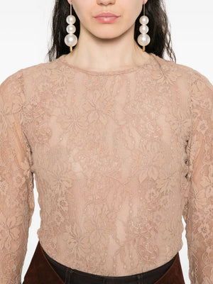 Full body shot of a woman in the Lace Bodysuit in Biscuit from Zimmermann, styled for a chic look.