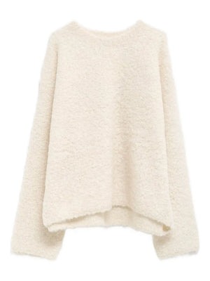 Boxy Boucle Knit in Milk by TOTEME showcasing the fluffy and curly texture of the sweater.